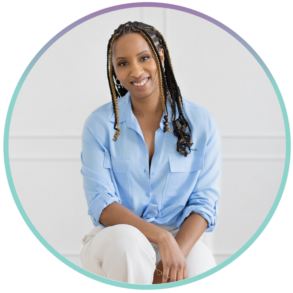 Nadia Hamilton is wearing a light blue shirt and white pants. She is posing for professional photos while sitting on a stool in front of a clean white wall.