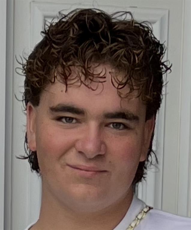 Chipp white is smiling for a headshot. He is wearing a gold chain and a white T-shirt.