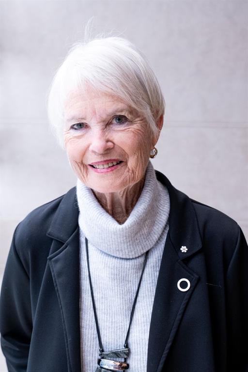 Dr. Robin Williams' is wearing a black coat over a grey turtleneck. She has her EKO Tribute Award pinned to her lapel.